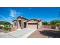 Beautiful single-story home with stone accents, well-kept yard, and a two-car garage at 1104 E Tekoa Ave, Gilbert, AZ 85298