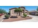 Lovely single-story home with desert landscaping, stone accents, and a two-car garage at 1104 E Tekoa Ave, Gilbert, AZ 85298