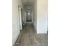 Hallway with tile flooring leading to a white front door and multiple rooms at 1519 N Etta St, Casa Grande, AZ 85122