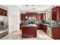 Elegant kitchen with stainless steel appliances, dark wood cabinetry, and a stylish backsplash, perfect for cooking at 1550 S Chaparral Blvd, Gilbert, AZ 85296