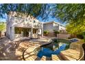 An inviting backyard showcasing a uniquely shaped pool, perfect for relaxation and outdoor entertainment at 1550 S Chaparral Blvd, Gilbert, AZ 85296