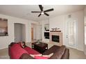 Cozy living room with a fireplace, entertainment center, and comfortable seating at 16420 N Thompson Peak Pkwy # 2020, Scottsdale, AZ 85260
