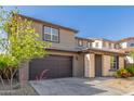 Stylish two-story home with a two-car garage and low-maintenance desert landscaping in the front yard at 17736 W Cassia Way, Goodyear, AZ 85338