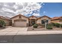 Beautiful single-Gathering home featuring a three-car garage and manicured desert landscaping at 17951 W Sammy Way, Surprise, AZ 85374
