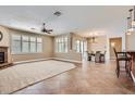 Open concept living room with tile floors, a ceiling fan, and natural light at 17951 W Sammy Way, Surprise, AZ 85374