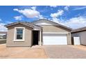 A single-story home with a two-car garage, neutral paint, and desert landscaping at 18268 W La Senda Dr, Surprise, AZ 85387