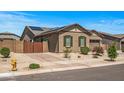 Beautiful single-story home featuring desert landscaping, solar panels, and a gated driveway at 18970 W Desert Hills Dr, Surprise, AZ 85388
