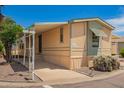 Street view of cozy home with covered parking and low maintenance landscaping at 201 S Greenfield Rd # 129, Mesa, AZ 85206