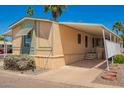 Well-maintained home featuring covered parking, mature landscaping and a neutral color scheme at 201 S Greenfield Rd # 129, Mesa, AZ 85206
