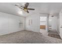 Sun-filled living room with light walls, neutral carpet, and doorway to other rooms at 201 S Greenfield Rd # 129, Mesa, AZ 85206