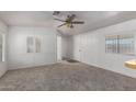 Bright and airy living room with neutral carpet, light walls, and an open doorway at 201 S Greenfield Rd # 129, Mesa, AZ 85206