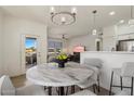 Open-concept dining area with stylish lighting, opening to living space and balcony at 20100 N 78Th Pl # 3084, Scottsdale, AZ 85255
