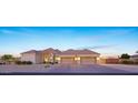 Spacious three car garage with brick-paved driveway complements the stylish exterior of this beautiful home at 20213 W Amelia Ave, Buckeye, AZ 85396
