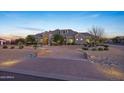 Elegant residence boasting an expansive circular driveway, desert landscaping, and a charming entrance at 20213 W Amelia Ave, Buckeye, AZ 85396