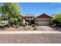 Charming single-story home with manicured landscaping and a spacious three-car garage at 20959 W Western Dr, Buckeye, AZ 85396