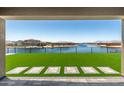 Captivating backyard with turf and water view, perfect for relaxing and entertaining guests at 22386 N Daniel Dr, Maricopa, AZ 85138