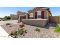 Cozy single-Gathering home featuring desert landscaping, providing a peaceful outdoor space at 22386 N Daniel Dr, Maricopa, AZ 85138