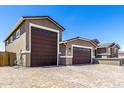 Spacious three car garage and paved driveway, offering ample parking at 22386 N Daniel Dr, Maricopa, AZ 85138