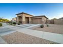 Single-story home with a two-car garage, desert landscaping, and wide driveway, offering curb appeal at 22601 E Via Las Brisas --, Queen Creek, AZ 85142