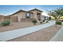 Well-maintained single-Gathering home with tidy desert landscaping and a welcoming walkway at 22601 E Via Las Brisas --, Queen Creek, AZ 85142
