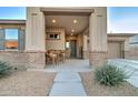 Inviting covered front porch with space for seating, complemented by brick accents at 22601 E Via Las Brisas --, Queen Creek, AZ 85142