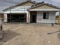 Construction stage featuring the exterior of the home with exposed framework and preparatory materials at 24072 W Bowker St, Buckeye, AZ 85326