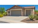 Beautiful home featuring stone accents, desert landscaping, and a three-car garage, excellent curb appeal at 26270 W Horsham Ct, Buckeye, AZ 85396