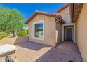 Home exterior featuring a private entry, desert landscaping, and a charming covered front porch, perfect curb appeal at 26270 W Horsham Ct, Buckeye, AZ 85396