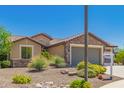 Beautiful home featuring stone accents, desert landscaping, and a well-maintained front yard, great curb appeal at 26270 W Horsham Ct, Buckeye, AZ 85396