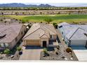 Beautiful desert home with a tile roof, lush landscaping, and a three car garage at 26421 W Zachary Dr, Buckeye, AZ 85396