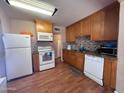 Functional kitchen with wooden cabinetry, essential appliances, and tiled backsplash for cooking and meal prep at 2729 W Keim Dr, Phoenix, AZ 85017