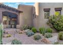 Desert home exterior with stone walkway and verdant succulent landscaping at 29308 N 108Th N Pl, Scottsdale, AZ 85262