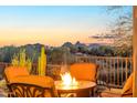 Cozy patio with seating around a fire pit and scenic mountain views at 29308 N 108Th N Pl, Scottsdale, AZ 85262