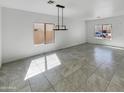Living room showcasing neutral paint, recessed lighting, and tile floors at 30271 W Crittenden Ln, Buckeye, AZ 85396