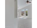 Bright living room featuring neutral carpet, vaulted ceilings, large windows, and ample natural light at 3531 N Sericin --, Mesa, AZ 85215