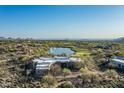 Scenic aerial view of the property showcasing a tranquil lake and lush golf course during a sunny day at 41611 N 113Th Pl, Scottsdale, AZ 85262