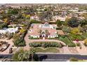 Expansive estate showcasing lush landscaping, a circular driveway, and a private pool, all viewed from above at 5220 N Casa Blanca Dr, Paradise Valley, AZ 85253