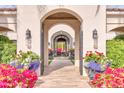 Elegant entry featuring an arched doorway, leading to a view of the home's manicured grounds and interior at 5220 N Casa Blanca Dr, Paradise Valley, AZ 85253