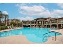 Resort-style swimming pool featuring an expansive sundeck, lounge chairs, and inviting blue water at 5450 E Deer Valley Dr # 1201, Phoenix, AZ 85054