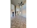 Inviting living room offering tile floors, a high ceiling, and natural light, creating a comfortable space at 5734 W Gwen St, Laveen, AZ 85339