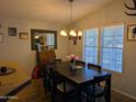 Inviting dining room with ample natural light, a modern chandelier, and seating for six at 7300 N 51St Ave # A259, Glendale, AZ 85301