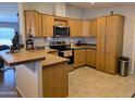 Well-equipped kitchen featuring stainless steel appliances, tile countertops, and ample cabinet space at 7300 N 51St Ave # A259, Glendale, AZ 85301