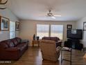 Cozy living room featuring hardwood flooring, neutral walls, and comfortable furnishings at 7300 N 51St Ave # A259, Glendale, AZ 85301