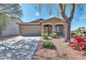 Charming one-story home featuring a two car garage, desert landscaping, and covered entry at 7433 W Darrel Rd, Laveen, AZ 85339