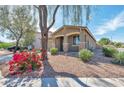 Lovely single-story home featuring desert landscaping, covered entryway, and attached garage at 7433 W Darrel Rd, Laveen, AZ 85339