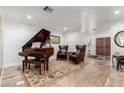 Living room with a grand piano, comfortable seating and a neutral color palette at 8031 N 12Th Ave, Phoenix, AZ 85021