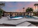 Stunning backyard pool and patio area at twilight, perfect for entertaining at 8031 N 12Th Ave, Phoenix, AZ 85021