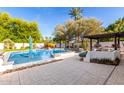 Inviting backyard featuring a pool, spa, and outdoor kitchen with built-in barbecue at 8031 N 12Th Ave, Phoenix, AZ 85021