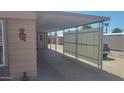 A convenient carport offers covered parking and easy access to the home at 8609 E Dewberry Ave, Mesa, AZ 85208