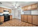 Spacious kitchen with wood cabinets and black appliances, offering ample counter space and storage at 9102 N 56Th Ln, Glendale, AZ 85302